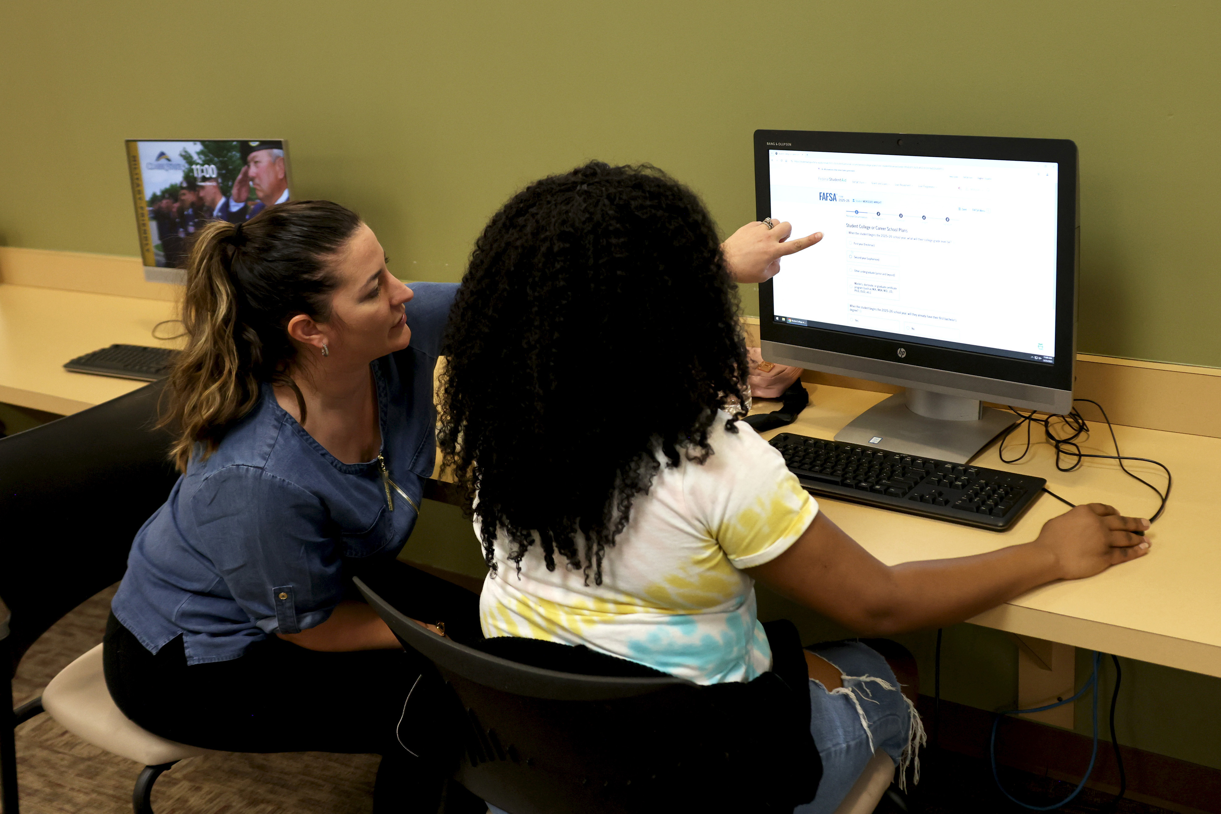 Financial Aid staff member helping student complete the FAFSA