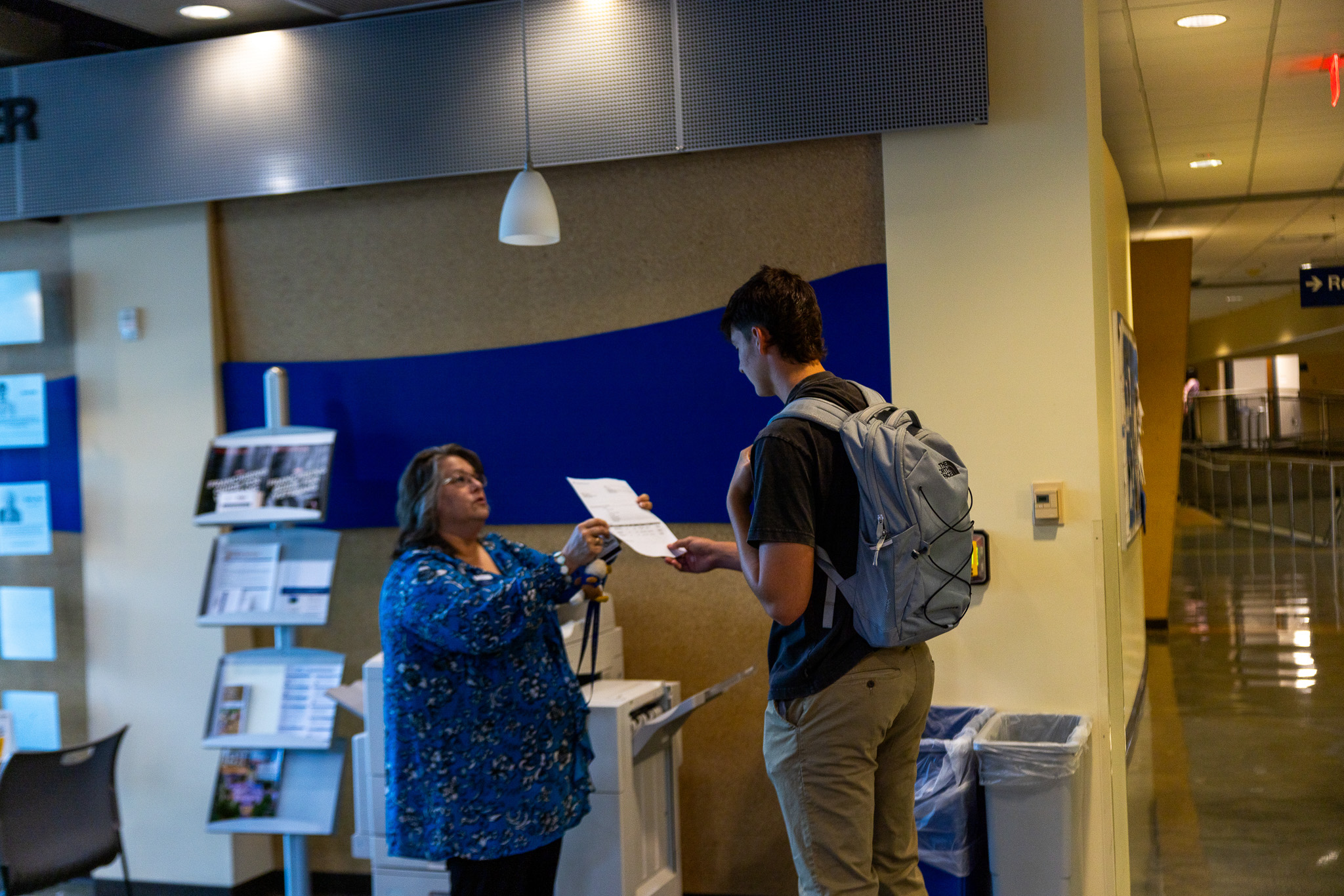 Staff member helping student